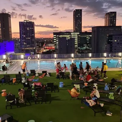 a group of people sitting on the roof of a building at Lovely Condo Unit in Miami