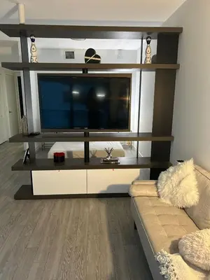 a living room with a large flat screen tv at Lovely Condo Unit in Miami