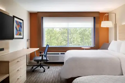 a hotel room with a bed and a desk and a window at Holiday Inn Express & Suites - Miramar by IHG in Miramar