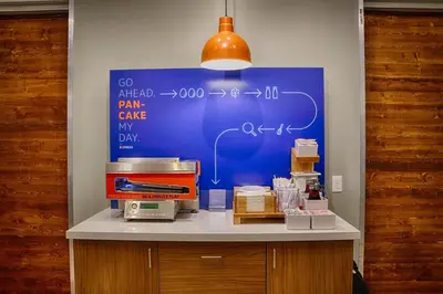 a counter with a blue board with formulas on it at Holiday Inn Express & Suites - Miramar by IHG in Miramar