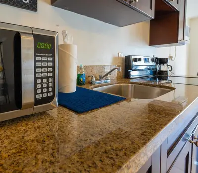 a kitchen counter with a microwave and a sink at COZY Private Apts in Hollywood By Hard Rock Casino! in Hollywood