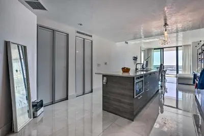 a kitchen with a counter and some glass windows at Luxe Miami Condo with Community Pool and Hot Tub! in Miami