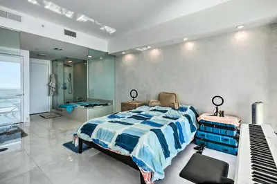 a bedroom with a bed and a sink and a piano at Luxe Miami Condo with Community Pool and Hot Tub! in Miami