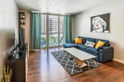 a living room with a couch and a tv at Dream Vacation Apartment Right On The Beach in Hollywood
