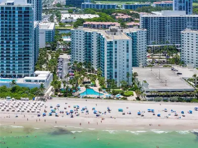 an aerial view of a beach with umbrellas and the ocean at Dream Vacation Apartment Right On The Beach in Hollywood