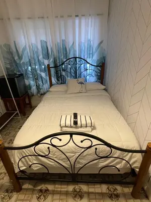a bedroom with a large bed with a white comforter at Habitacion Centrica Calle 8 Miami (2) in Miami