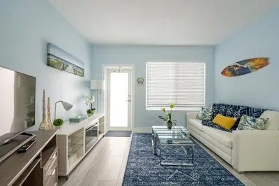 a living room with blue walls and a white couch at The Surf Hollywood Beach in Hollywood