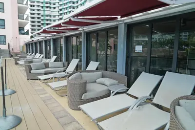 a row of chairs and tables on a patio at Deluxe Apartments by South Florida Vacations in Miami Beach