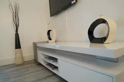 a mirror sitting on top of a white dresser at Deluxe Apartments by South Florida Vacations in Miami Beach