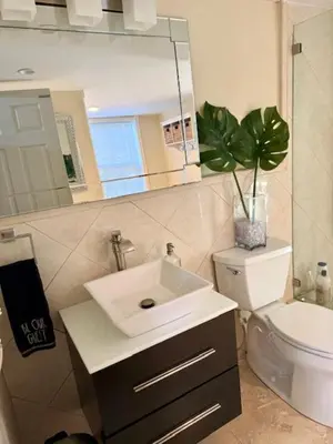 a bathroom with a sink and a toilet and a mirror at Homestay Weston Ranches in Southwest Ranches