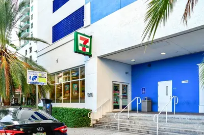 a blue and white building with a car parked outside at Trendy 2BR Condo with Pool and Bay Views in Miami