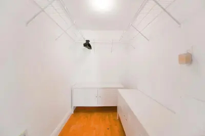 a white room with a desk and a light on the ceiling at Trendy 2BR Condo with Pool and Bay Views in Miami