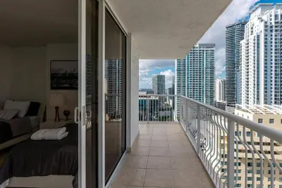 a balcony with a bed and a view of a city at Beautiful 3 bedroom apartment in Brickell Miami in Miami