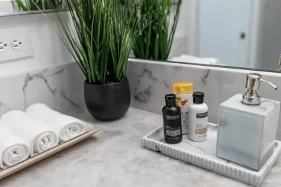 a bathroom counter with towels and bottles of soap at Beautiful 3 bedroom apartment in Brickell Miami in Miami
