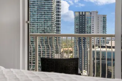 a bedroom with a bed and a view of a city at Beautiful 3 bedroom apartment in Brickell Miami in Miami