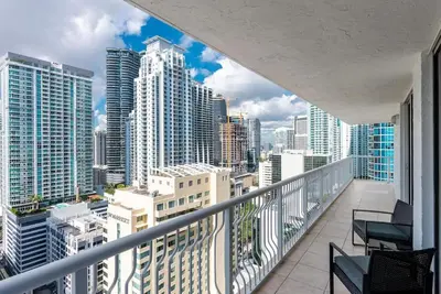 a balcony with chairs and a view of a city at Beautiful 3 bedroom apartment in Brickell Miami in Miami