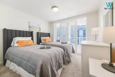 a bedroom with two beds and a large window at Amazing 3BR Condo at Brickell with City Views in Miami