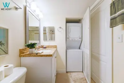 a small bathroom with a washer and dryer in it at Amazing 3BR Condo at Brickell with City Views in Miami