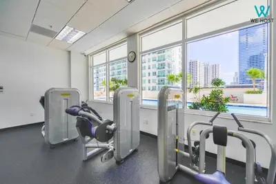 a gym with a view of a city from a window at Amazing 3BR Condo at Brickell with City Views in Miami