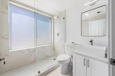 a bathroom with a toilet and a sink and a shower at SOBE suites in Miami Beach in Miami Beach