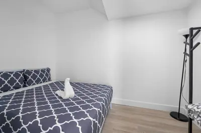 a bedroom with a bed with a white stuffed animal on it at SOBE suites in Miami Beach in Miami Beach