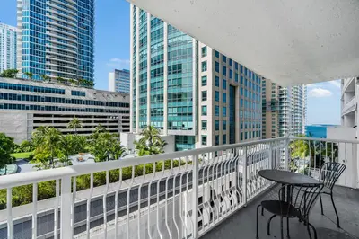 a balcony with a table and chairs and buildings at Luxurious 3BR Condo with Pool in Brickell in Miami