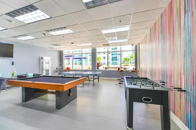 a room with two billiard tables and a colorful wall at Luxurious 3BR Condo with Pool in Brickell in Miami