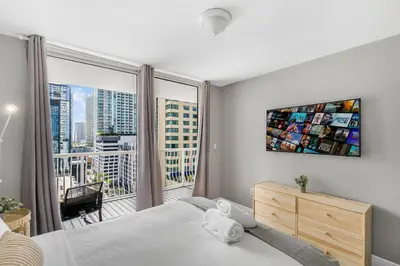a bedroom with a bed and a large window at Luxurious 3BR Condo with Pool in Brickell in Miami