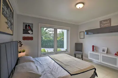 a bedroom with a large bed and a window at Miami Home Outdoor Pool with Slide and Fire Pit! in Kendall