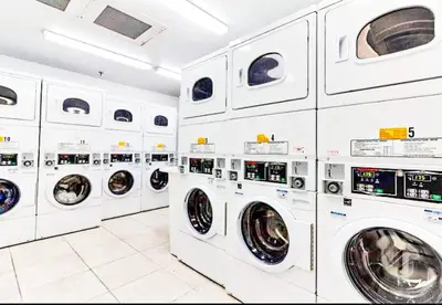 a bunch of white washing machines in a laundrette at Castle 1131 in Miami Beach