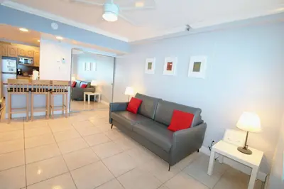 a living room with a couch and a kitchen at Castle 1131 in Miami Beach