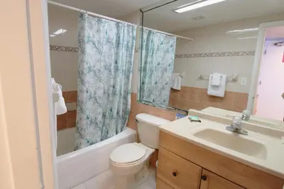a bathroom with a toilet and a tub and a sink at Castle 1131 in Miami Beach
