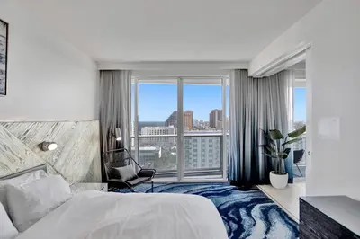 a hotel room with a bed and a large window at WVR Vacation Residences 1707 in Fort Lauderdale