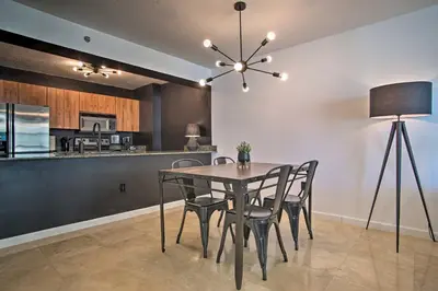 a dining room with a table and chairs and a kitchen at Waterfront Condo with View about 6 Miles to South Beach! in Miami