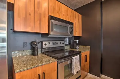 a kitchen with a stove and a microwave at Waterfront Condo with View about 6 Miles to South Beach! in Miami