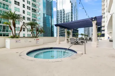 a swimming pool in the middle of a city with tall buildings at Waterfront Condo with View about 6 Miles to South Beach! in Miami