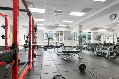 a gym with a lot of chairs and weights at Waterfront Condo with View about 6 Miles to South Beach! in Miami