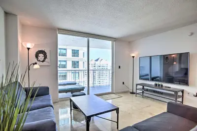 a living room with a couch and a large window at Waterfront Condo with View about 6 Miles to South Beach! in Miami