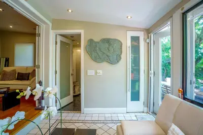 a living room with a door and a couch at Entire private Beautiful 2 Bedroom plus Den House with gated front&back yard and Free parking 10min drive to Miami Beach in Miami