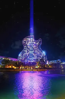 a building with a guitar lit up at night at Hard Rock Hidden Gem! in Miami Gardens