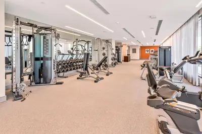 a large gym with treadmills and cardio machines at Luxury Studio Apartment in Downtown Doral in Miami