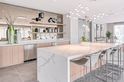 a kitchen with a large white island in a room at Luxury Studio Apartment in Downtown Doral in Miami