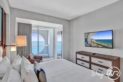 a bedroom with a bed and a desk with a mirror at 1BR condo w hot tub gym access in Fort Lauderdale