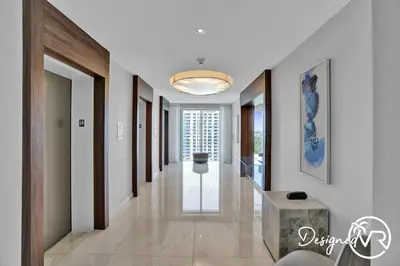 a hallway of a home with a table in the middle at 1BR condo w hot tub gym access in Fort Lauderdale