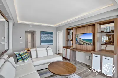 a living room with a white couch and a tv at 1BR condo w hot tub gym access in Fort Lauderdale