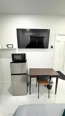 a living room with a table and a tv at Private Rooms close to Miami Airport - Free parking - 01 in Miami