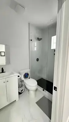 a white bathroom with a toilet and a shower at Private Rooms close to Miami Airport - Free parking - 01 in Miami