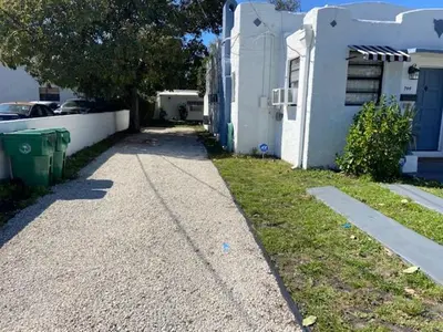 a sidewalk next to a house next to a house at Private Room near Miami Airport - Free parking - 01 in Miami