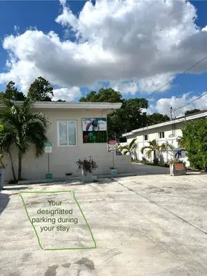 a house with a sign in front of it at Stunning Little Havana Suites Close to airport, Calle Ocho, Brickell, Wynwood and the Beaches - Free Parking in Miami