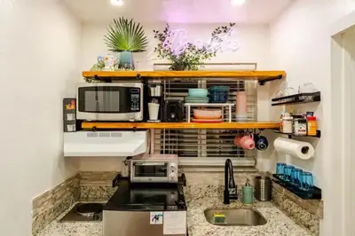 a kitchen with a sink and a microwave at Stunning Little Havana Suites Close to airport, Calle Ocho, Brickell, Wynwood and the Beaches - Free Parking in Miami